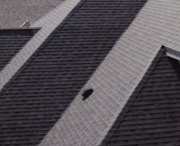 aerial-footage-of-element-new-roof-is-installed-on-a-house-day-time-SBI-350900831