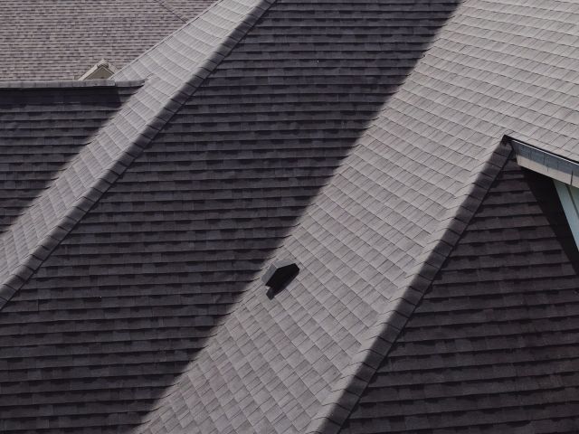 aerial-footage-of-element-new-roof-is-installed-on-a-house-day-time-SBI-350900831